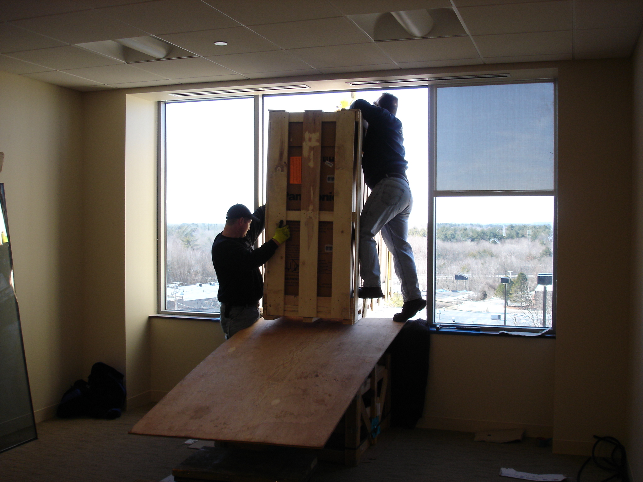 crane bringing equipment inside through window