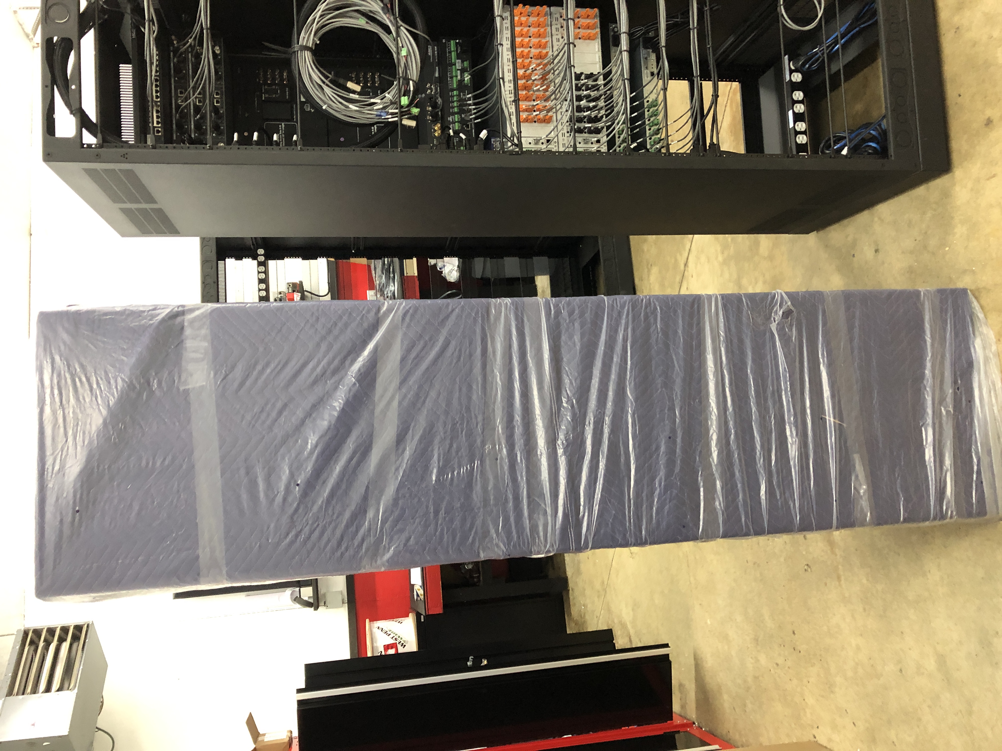 rack in transport blanket and plastic cover