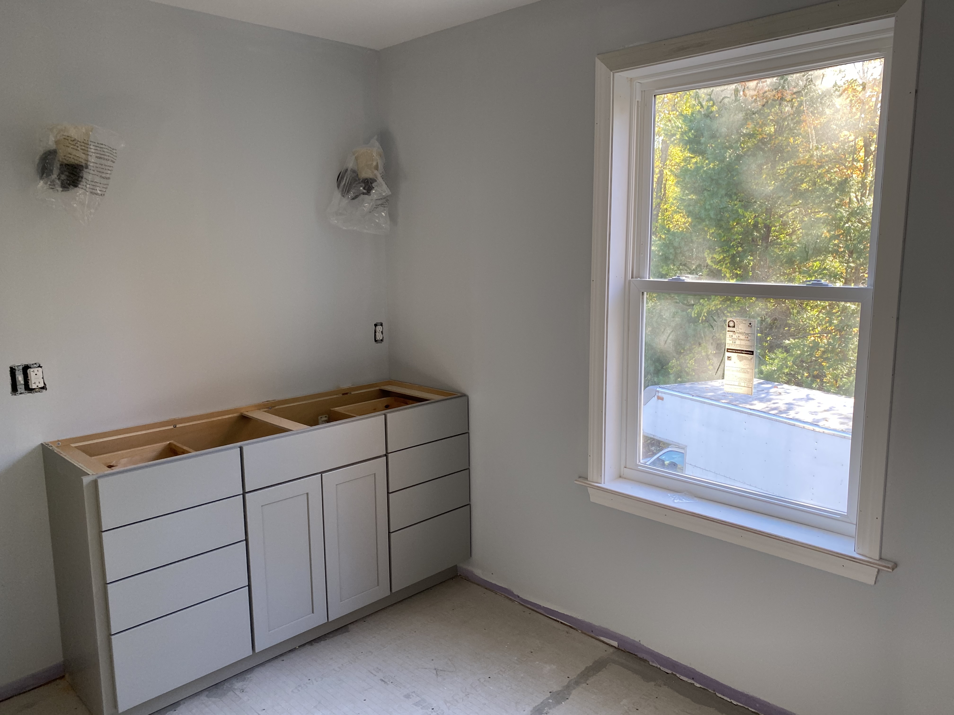 remodeled room with new cabinets without countertops